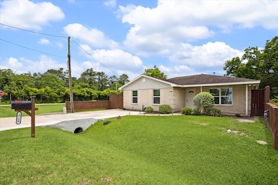 Features a newly extended paved driveway and a woo