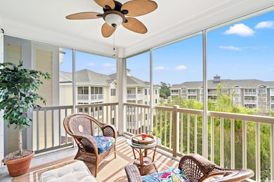 Sunroom / solarium with a residential view and a ceiling fan