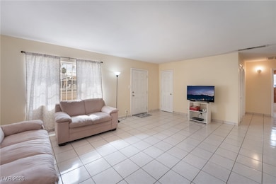 Living room with light tile patterned floors and baseboards