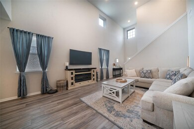 Living area with wood finished floors, stairway, 