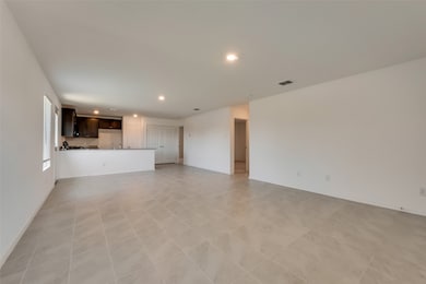 Unfurnished living room featuring recessed lighting and light tile patterned flooring