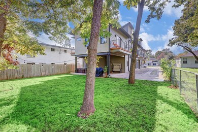 Back of house featuring a fenced backyard, a balc