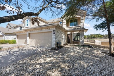 View of front of home featuring stone siding, con