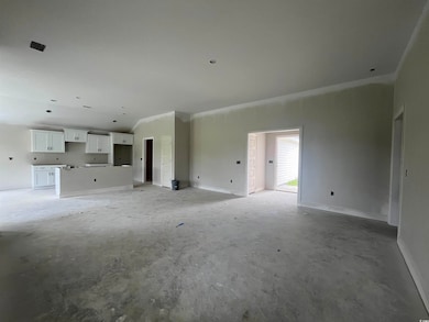Unfurnished living room featuring concrete flooring and baseboards