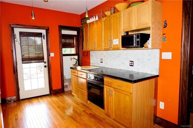 Covered back porch & 1/2 bath off open kitchen