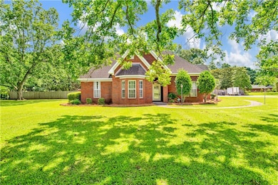 View of front of house featuring brick siding and roof with shingles