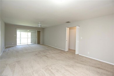 Carpeted empty room with ceiling fan