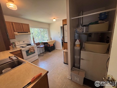 Kitchen view 2 showing clothes washer and water heater closet.