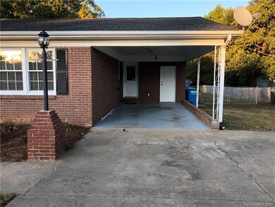 One car carport and covered entry to the house.