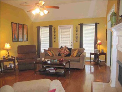 LARGE LIVING ROOM WITH HARDWOOD FLOORS.