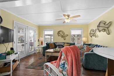 Living room with ceiling fan, wood finished floors