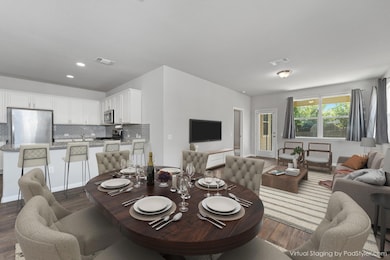 Dining area with dark wood-style flooring and rec