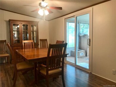 Dining area open to kitchen and sunroom.
