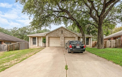 Single story home with a garage, fence, concrete 