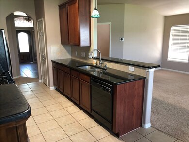 Another view of kitchen showing open view to family room
