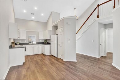 Open concept. Classic white cabinets, pantry, frig conveys.  Love the high ceilings and recessed lighting.  Room to customize and add island or bar stool seating if so desired.