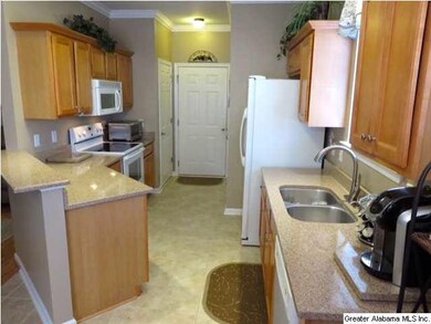 The kitchen is upgraded with quartz countertops, c
