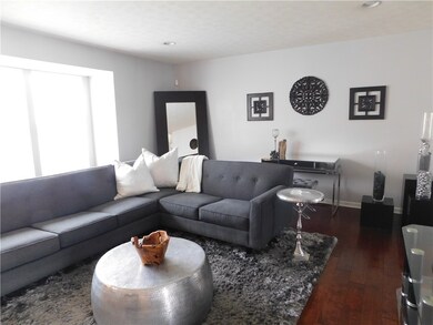The living room shows the new engineered hardwood