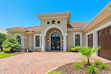 Entrance to property featuring french doors, a tiled roof, and stucco siding