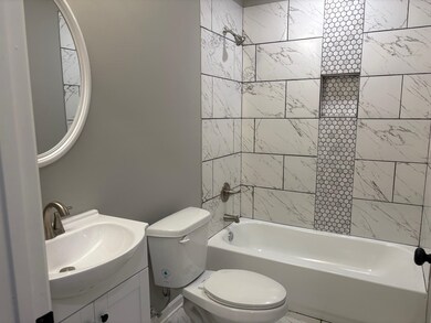 Bathroom featuring washtub / shower combination and vanity