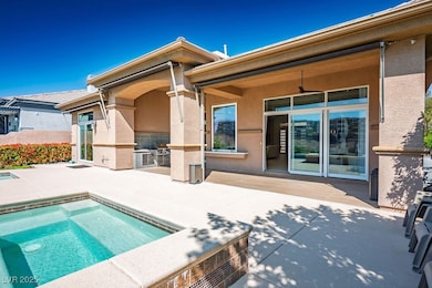 Rear view of house featuring an outdoor kitchen, a