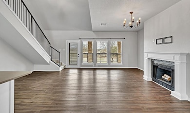 From the kitchen, view the living area flowing wit