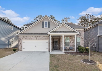 View of front of house featuring concrete driveway
