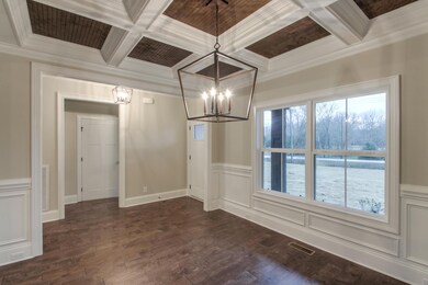 Coffered ceilings in the dining room with stained bead board gives this space a regal look. 