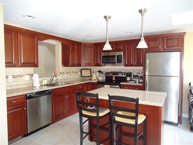 Cherry cabinetry, tile floor,...