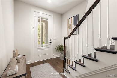 Foyer with stairway, wood finished floors, and bas