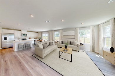 Living room featuring light wood finished floors and recessed lighting