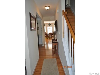 Foyer with wood flooring and hallway to rest of 1s