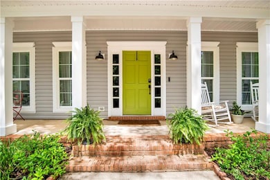 Doorway to property featuring a porch