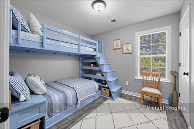 Bedroom with light wood-style flooring and baseboards