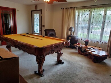 Living room so big that it will hold a pool table
