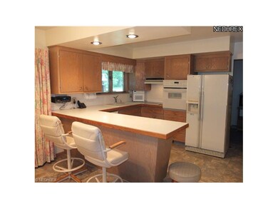 Fully applianced kitchen with breakfast bar.