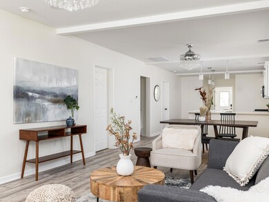Living room with baseboards, visible vents, light
