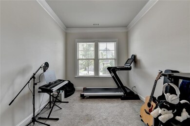 Workout area with carpet flooring and ornamental molding