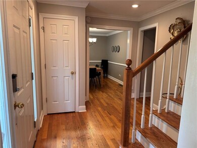 Corridor featuring an inviting chandelier, stairs,