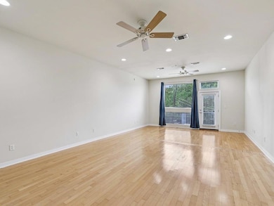 Spare room featuring baseboards, ceiling fan, lig