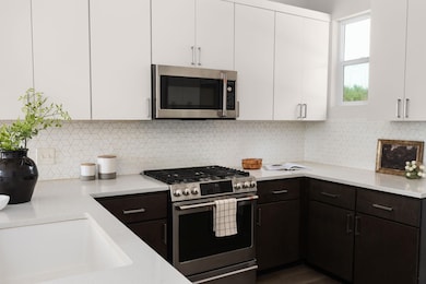 Kitchen with stainless steel appliances, light co