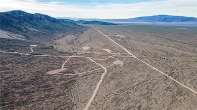 View of mountain backdrop with rural landscape and a desert landscape