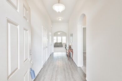 Bright entryway with high ceilings, elegant arched