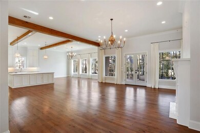 great room, wood floors, chandelier,wood beams, re