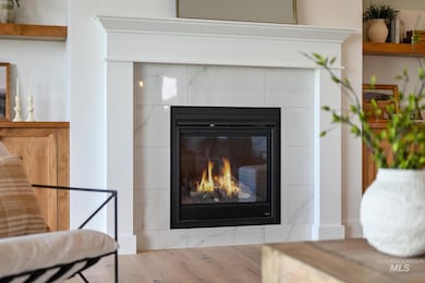 Detailed view of wood finished floors and a fireplace
