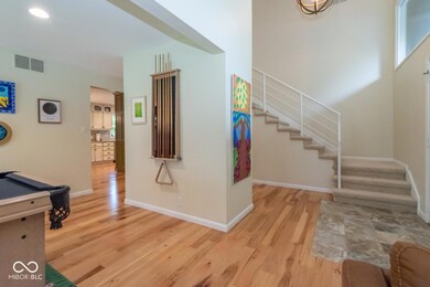 entrance foyer with light wood finished floors, stairs, billiards, and recessed lighting
