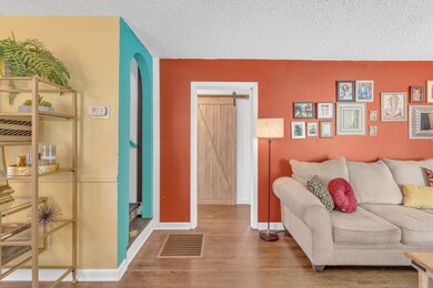 The warm inviting wall colors, beautiful natural light from the windows, and hardwoods greet guests as they arrive