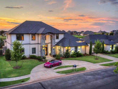 French country inspired facade featuring curved driveway, a shingled roof, stucco siding, stone siding, and a lawn