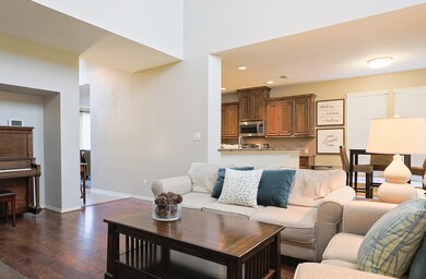 Open concept Family Room with wall of windows, vaulted ceilings, and even room for a piano or large furniture.