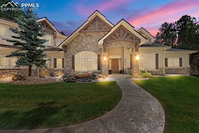 French provincial home with stone siding, a yard, and stucco siding